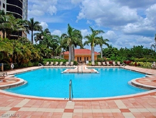 1050 Borghese Ln Unit 1804, Naples, FL 34114 - community pool featuring a patio