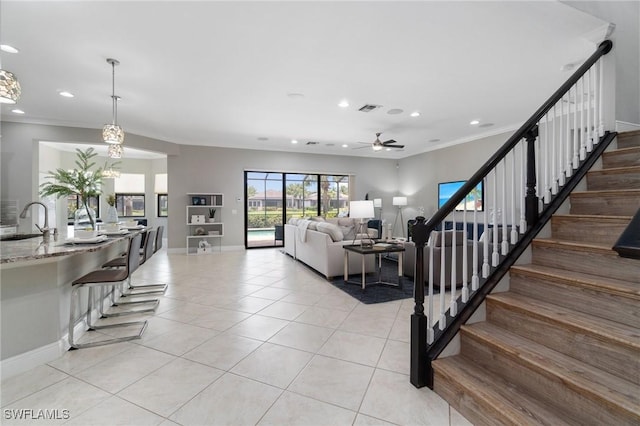 4437 Tamarind Way, Naples, FL 34119 - living area featuring light tile patterned floors, a ceiling fan, recessed lighting, stairs, and ornamental molding