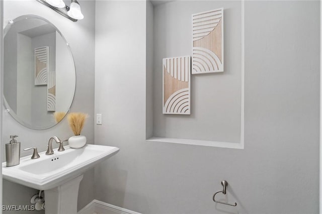 4437 Tamarind Way, Naples, FL 34119 - bathroom featuring baseboards and a sink