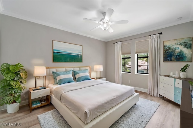 4437 Tamarind Way, Naples, FL 34119 - bedroom with crown molding, light wood-style floors, baseboards, and a ceiling fan