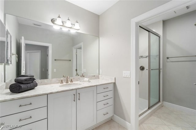 4437 Tamarind Way, Naples, FL 34119 - full bathroom with vanity, a stall shower, tile patterned floors, and baseboards