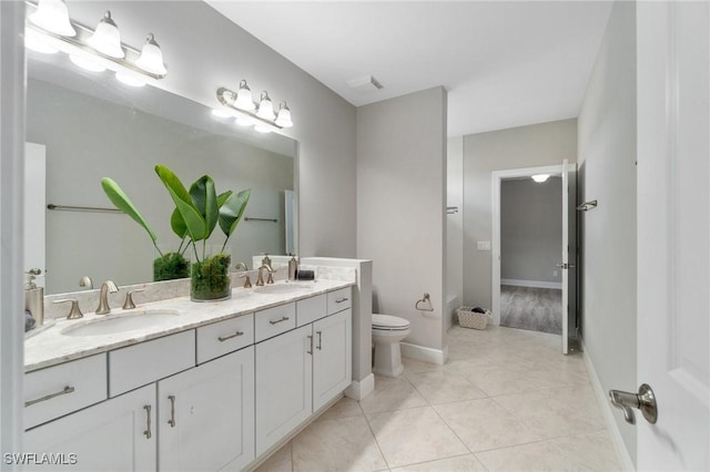 4437 Tamarind Way, Naples, FL 34119 - bathroom featuring double vanity, toilet, tile patterned flooring, and baseboards