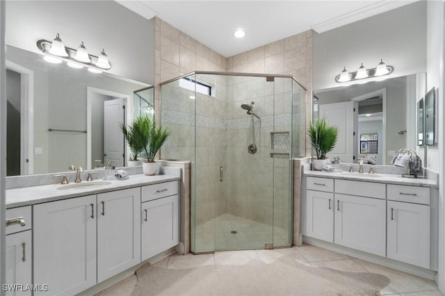 4437 Tamarind Way, Naples, FL 34119 - bathroom with two vanities, a stall shower, ornamental molding, and tile patterned flooring