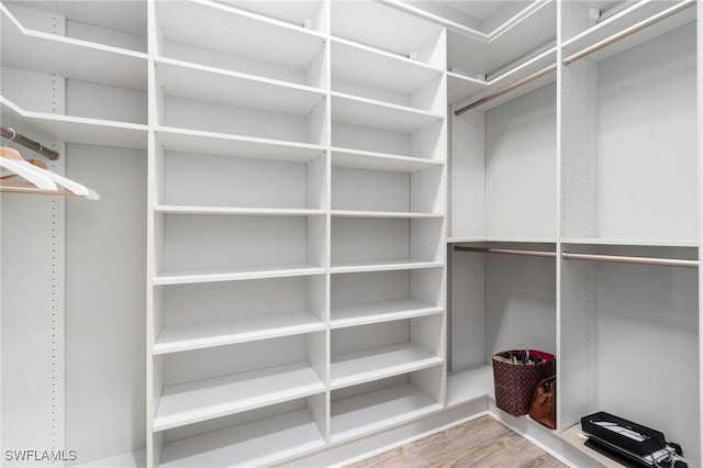 4437 Tamarind Way, Naples, FL 34119 - walk in closet featuring wood finished floors