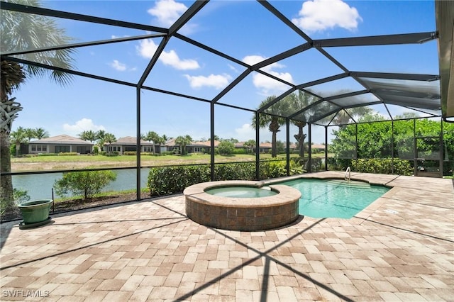 4437 Tamarind Way, Naples, FL 34119 - view of pool featuring a water view, a patio area, a pool with connected hot tub, and a lanai