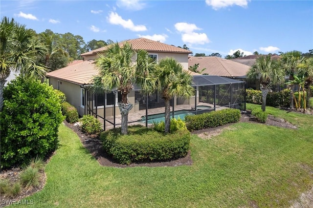 4437 Tamarind Way, Naples, FL 34119 - rear view of house featuring a tile roof, stucco siding, a lawn, an outdoor pool, and glass enclosure