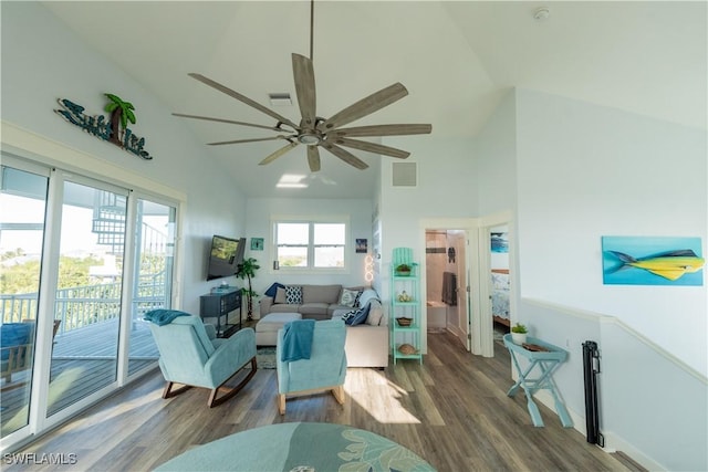 living area featuring high vaulted ceiling, wood finished floors, and a ceiling fan