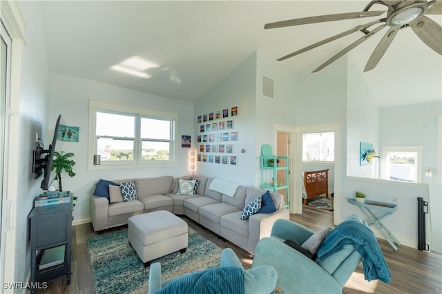 living room featuring wood finished floors, a ceiling fan, high vaulted ceiling, and baseboards