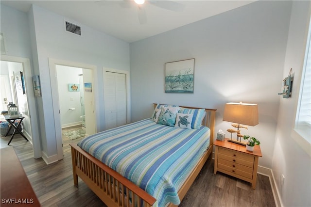bedroom featuring wood finished floors, ensuite bath, baseboards, and a closet