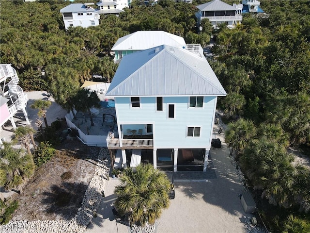 view from above of property featuring a tree filled landscape
