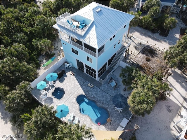 aerial view of property and surrounding area featuring a pool area