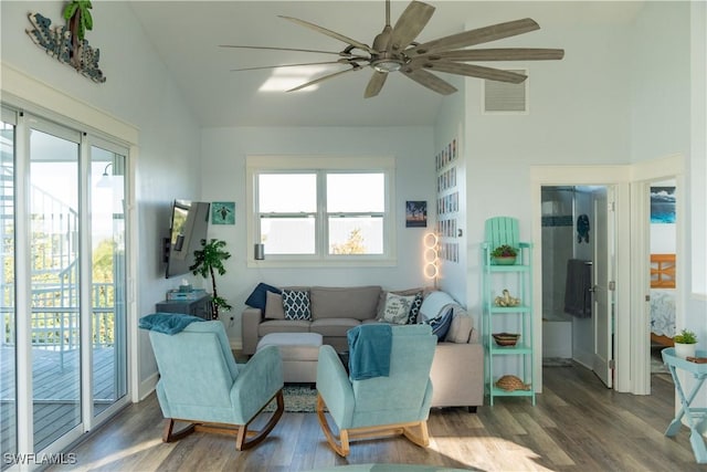 living area with lofted ceiling, a ceiling fan, and wood finished floors