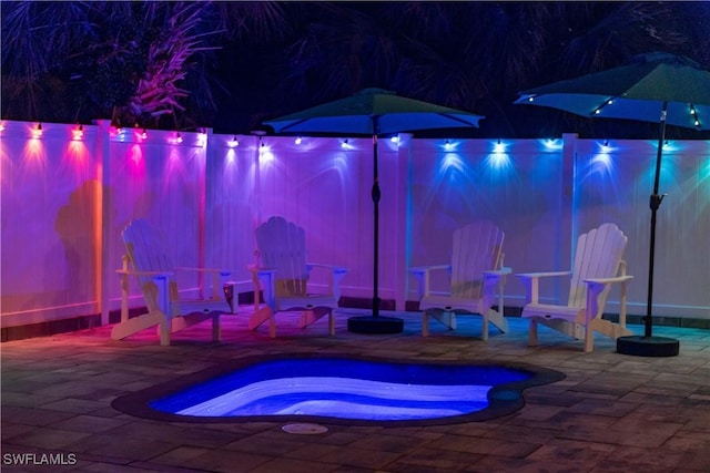patio at twilight with a hot tub