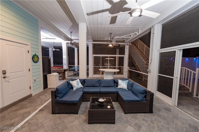 sunroom with ceiling fan and outdoor lounge area