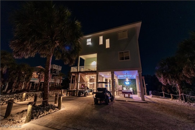 view of back of house at night