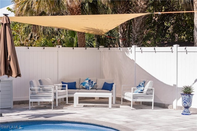 view of swimming pool featuring a patio, fence, and an outdoor hangout area