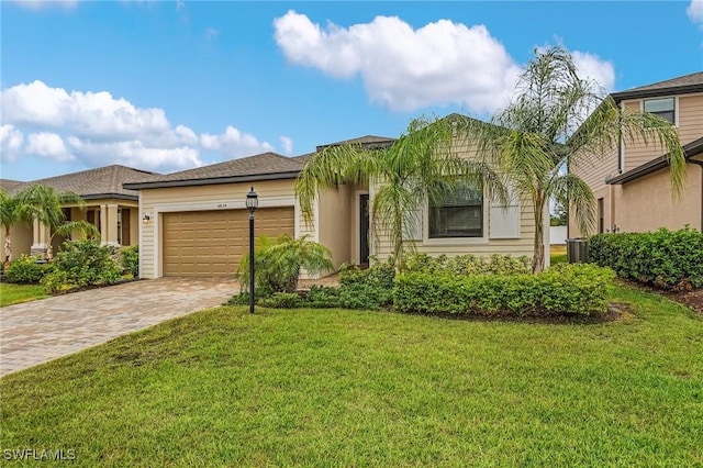 14634 Cantabria Dr, Fort Myers, FL 33905 - view of front of home with an attached garage, a front lawn, central AC, and driveway
