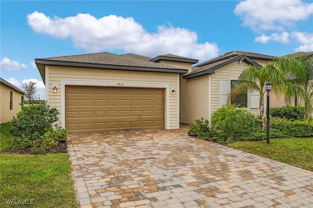 14634 Cantabria Dr, Fort Myers, FL 33905 - view of front of property with an attached garage and decorative driveway