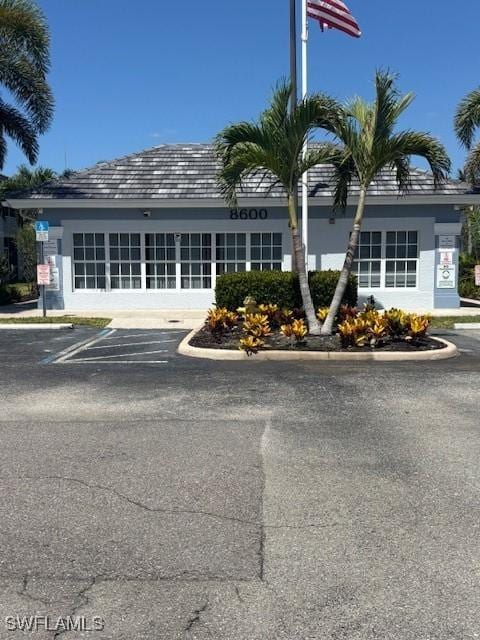 view of building exterior featuring uncovered parking