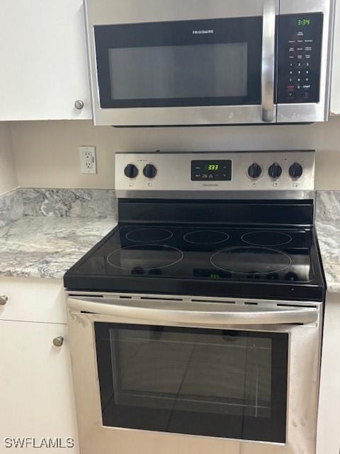 8326 Bernwood Cove Loop Unit 901, Fort Myers, FL 33966 - kitchen view of stainless steel appliances and white cabinetry