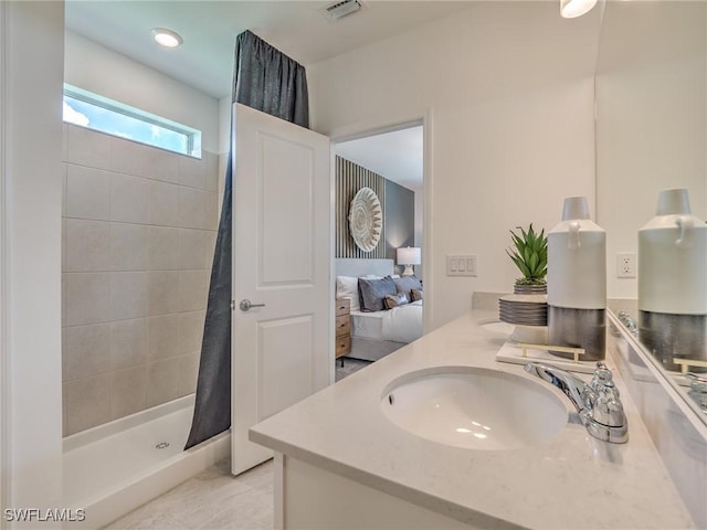 ensuite bathroom with connected bathroom, vanity, visible vents, and a stall shower