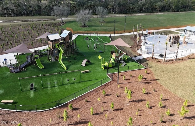 community playground featuring a lawn and fence