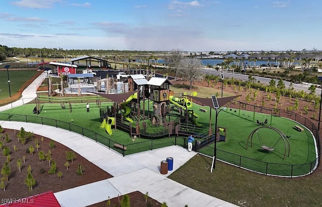 surrounding community with a yard, playground community, and fence