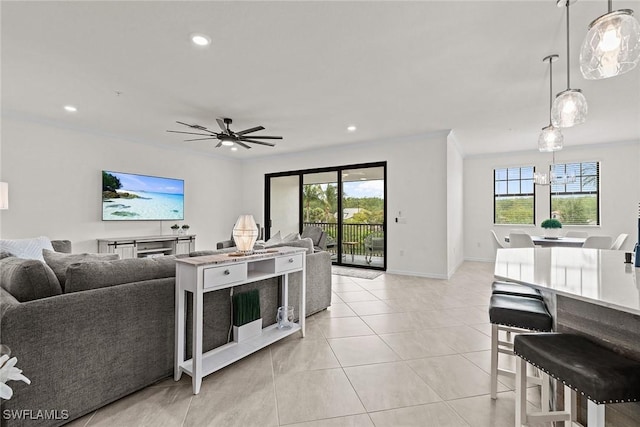 11792 Grand Belvedere Way Unit 202, Fort Myers, FL 33913 - living room featuring light tile patterned floors, crown molding, baseboards, ceiling fan, and recessed lighting