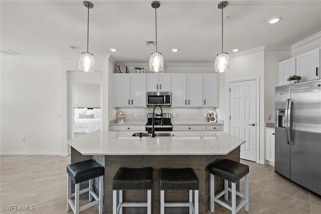 11792 Grand Belvedere Way Unit 202, Fort Myers, FL 33913 - kitchen featuring appliances with stainless steel finishes, crown molding, decorative backsplash, a kitchen breakfast bar, and white cabinetry