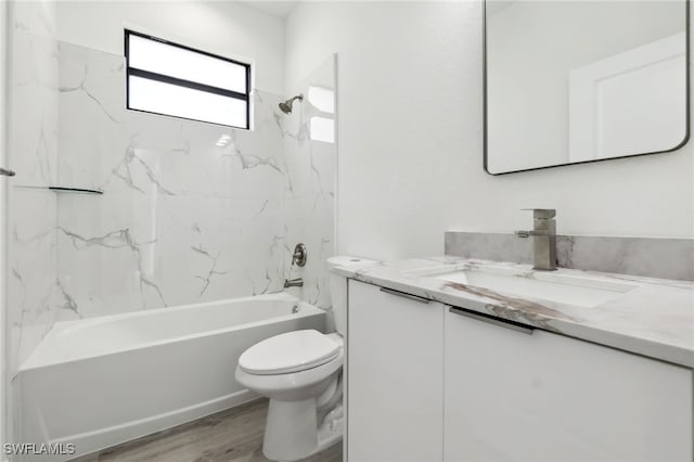 full bathroom featuring toilet, wood finished floors, vanity, and  shower combination