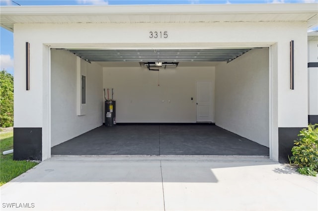garage featuring concrete driveway, electric water heater, and a garage door opener