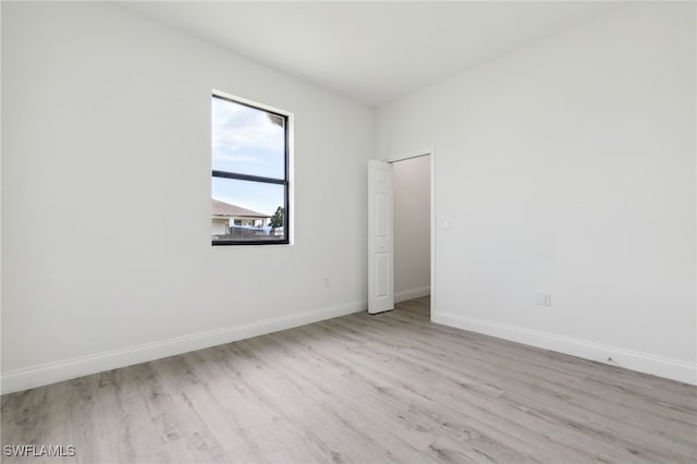 unfurnished room featuring baseboards and wood finished floors