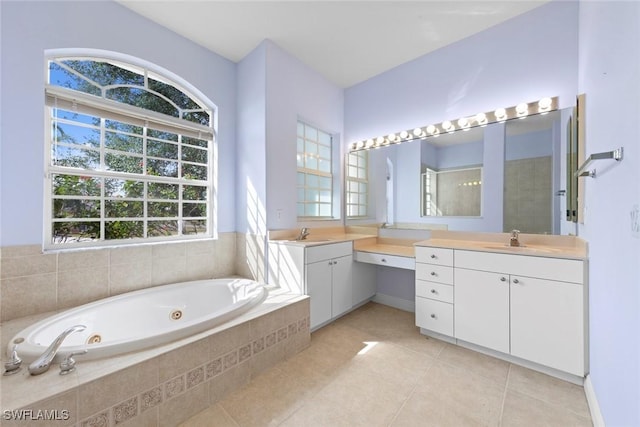 15461 River Cove Ct, North Fort Myers, FL 33917 - bathroom featuring a jetted tub, tile patterned floors, two vanities, and a sink