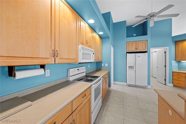 15461 River Cove Ct, North Fort Myers, FL 33917 - kitchen featuring light brown cabinets, light tile patterned floors, white appliances, ceiling fan, and high vaulted ceiling