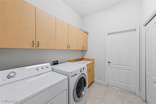 15461 River Cove Ct, North Fort Myers, FL 33917 - laundry room featuring washing machine and dryer, a sink, cabinet space, baseboards, and light tile patterned flooring