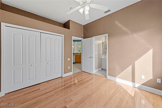 15461 River Cove Ct, North Fort Myers, FL 33917 - unfurnished bedroom with a closet, baseboards, visible vents, connected bathroom, and wood finished floors