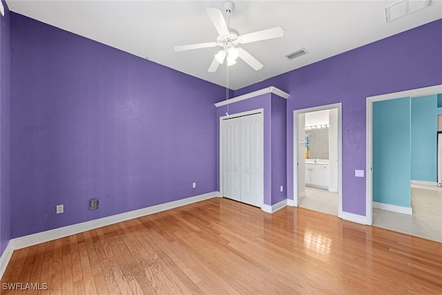 15461 River Cove Ct, North Fort Myers, FL 33917 - unfurnished bedroom featuring baseboards, a closet, visible vents, and wood finished floors