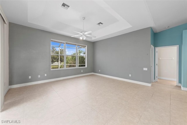 15461 River Cove Ct, North Fort Myers, FL 33917 - empty room featuring a tray ceiling, light tile patterned floors, visible vents, and ceiling fan