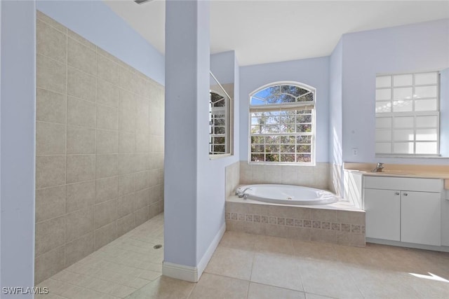 15461 River Cove Ct, North Fort Myers, FL 33917 - bathroom with a wealth of natural light, tile patterned floors, vanity, and a bath