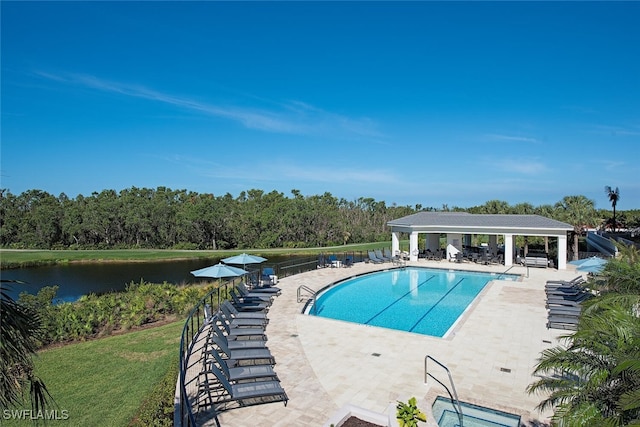 community pool with a water view, a patio area, a gazebo, and fence