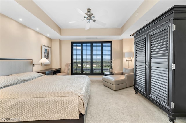 bedroom featuring light colored carpet, visible vents, recessed lighting, ceiling fan, and a raised ceiling