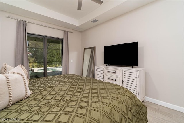 unfurnished bedroom with visible vents, light wood finished floors, a ceiling fan, baseboards, and access to exterior