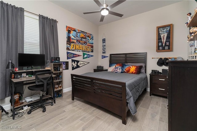 bedroom with baseboards, a ceiling fan, and wood finished floors