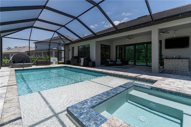 view of swimming pool featuring a patio, a pool with connected hot tub, and a ceiling fan