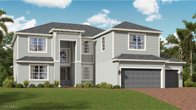 view of front facade featuring an attached garage, decorative driveway, and a front yard