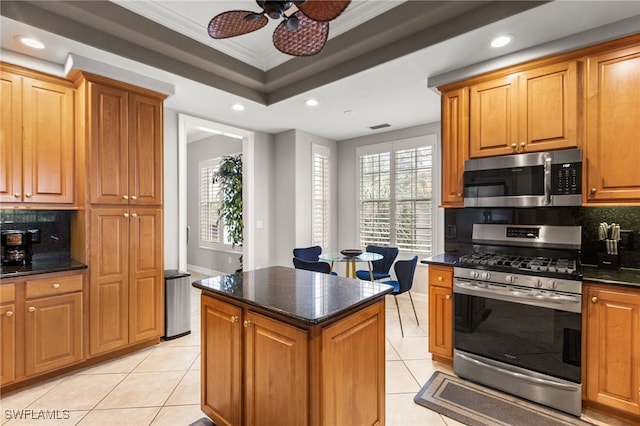 11239 Bienvenida Ct Unit 11C, Fort Myers, FL 33908 - kitchen with stainless steel appliances, light tile patterned floors, backsplash, crown molding, and recessed lighting