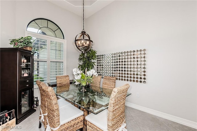 7307 Acorn Way, Naples, FL 34119 - dining room featuring a chandelier, light tile patterned floors, baseboards, and high vaulted ceiling