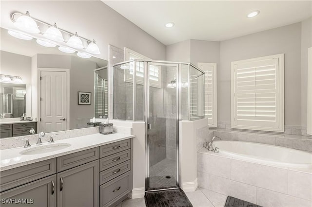 7307 Acorn Way, Naples, FL 34119 - full bath featuring vanity, a garden tub, a stall shower, tile patterned flooring, and recessed lighting