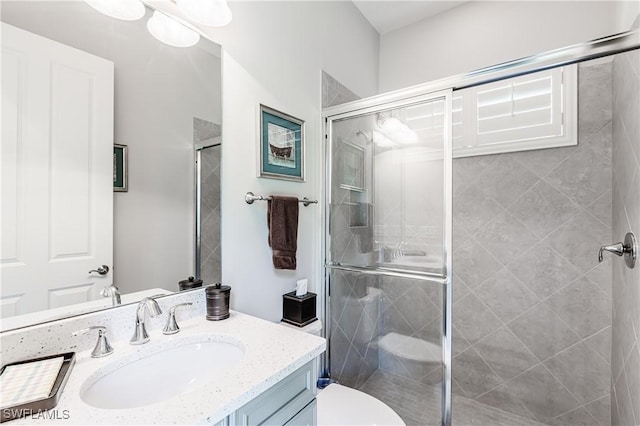 7307 Acorn Way, Naples, FL 34119 - bathroom featuring vanity, a stall shower, and toilet