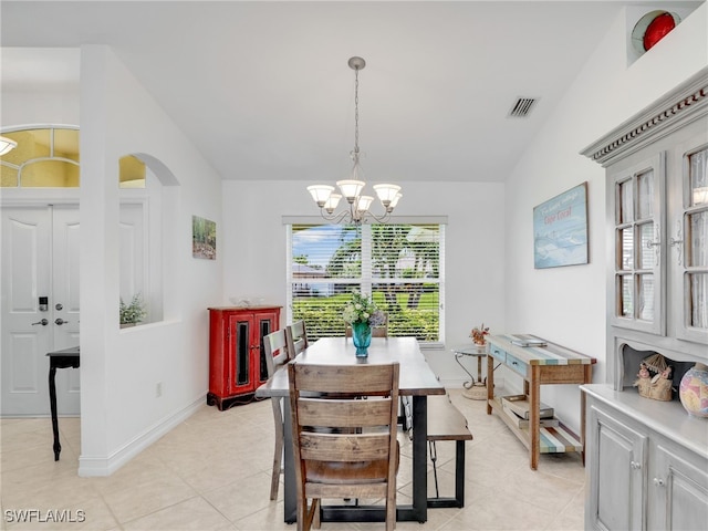 201 SE 4th St, Cape Coral, FL 33990 - dining space featuring lofted ceiling, visible vents, a chandelier, light tile patterned floors, and baseboards